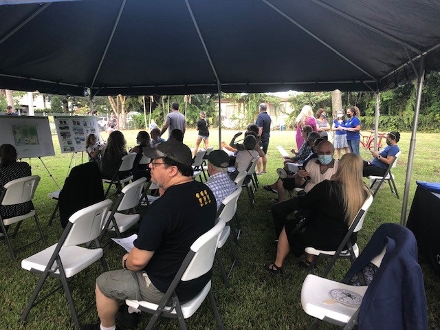 Residents under a tent in an open field for the 3699/3701 SW 1 Avenue Mini Park Final Community Meeting 