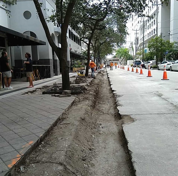 Construction workers working on the road and drainage at Mary Brickell Village