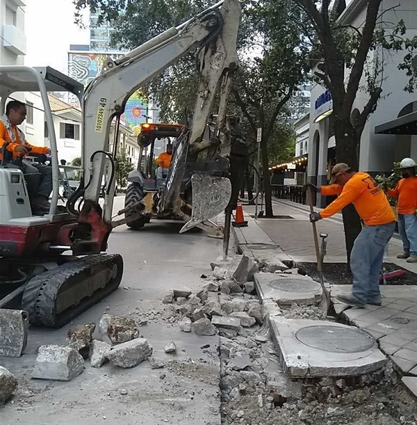 Construction workers working on the road and drainage at Mary Brickell Village