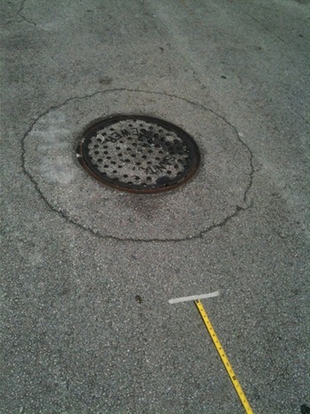 Manhole in need of repair in La Pastorita Neighborhood